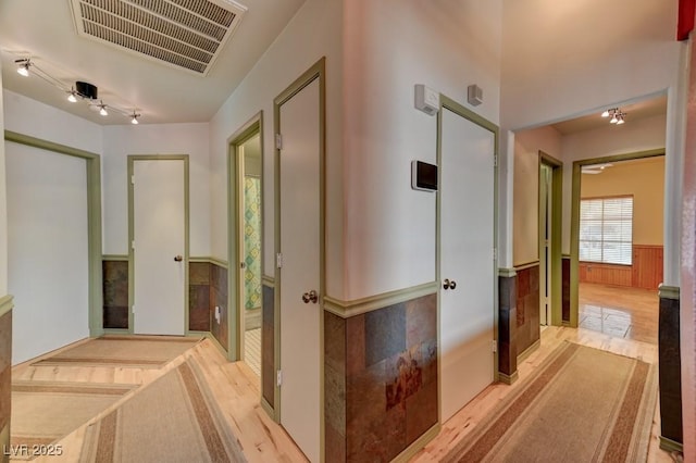 1523 Silver Point Ave, Las Vegas, NV 89123 - corridor featuring a wainscoted wall and light wood-style flooring