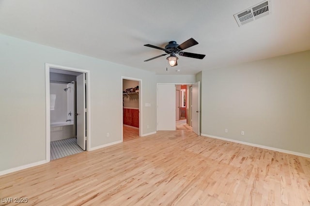 1523 Silver Point Ave, Las Vegas, NV 89123 - unfurnished bedroom with wood finished floors, a spacious closet, baseboards, and ensuite bath