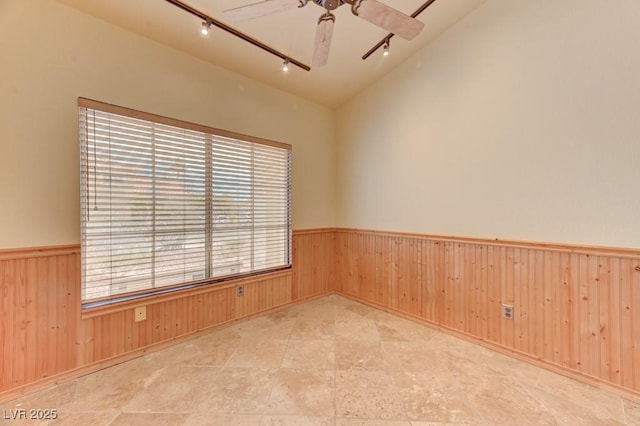 1523 Silver Point Ave, Las Vegas, NV 89123 - spare room with track lighting, wainscoting, a ceiling fan, wooden walls, and lofted ceiling