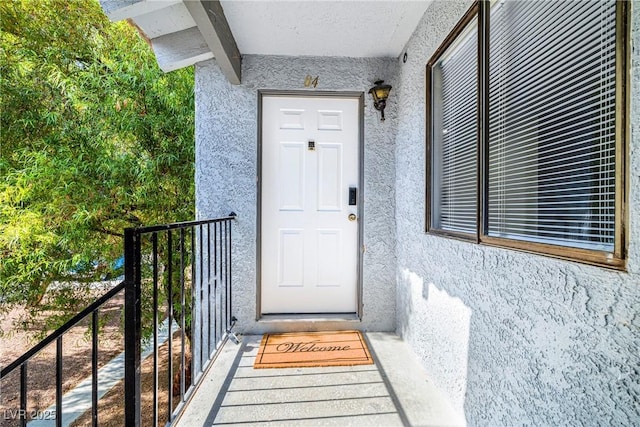 5191 Caliente St Unit 84, Las Vegas, NV 89119 - doorway to property featuring stucco siding and a balcony