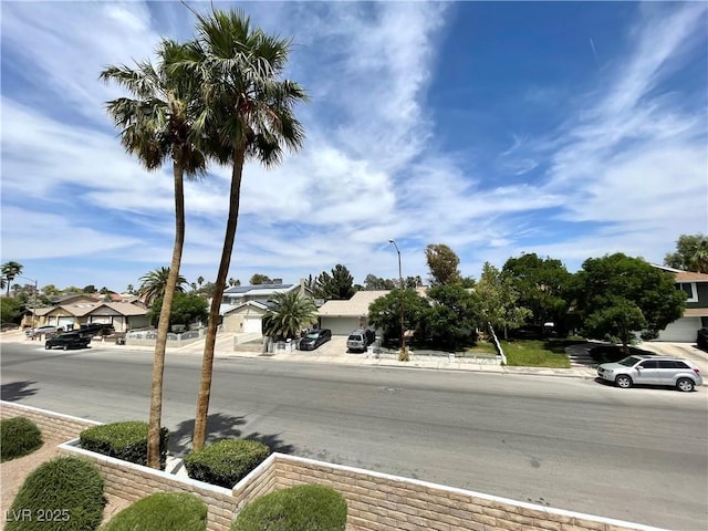 5191 Caliente St Unit 84, Las Vegas, NV 89119 - view of asphalt street featuring a residential view, sidewalks, and street lights