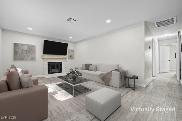 5191 Caliente St Unit 84, Las Vegas, NV 89119 - living room featuring wood finished floors, baseboards, recessed lighting, and a brick fireplace