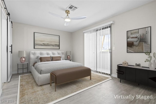 5191 Caliente St Unit 84, Las Vegas, NV 89119 - bedroom with light wood-type flooring, access to outside, baseboards, and a barn door