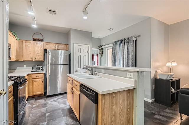 6321 Rolling Rose St Unit 201, North Las Vegas, NV 89081 - kitchen with appliances with stainless steel finishes, track lighting, light countertops, and light brown cabinets