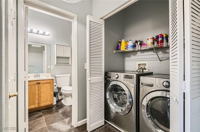 6321 Rolling Rose St Unit 201, North Las Vegas, NV 89081 - washroom featuring independent washer and dryer, dark tile patterned floors, and a textured wall
