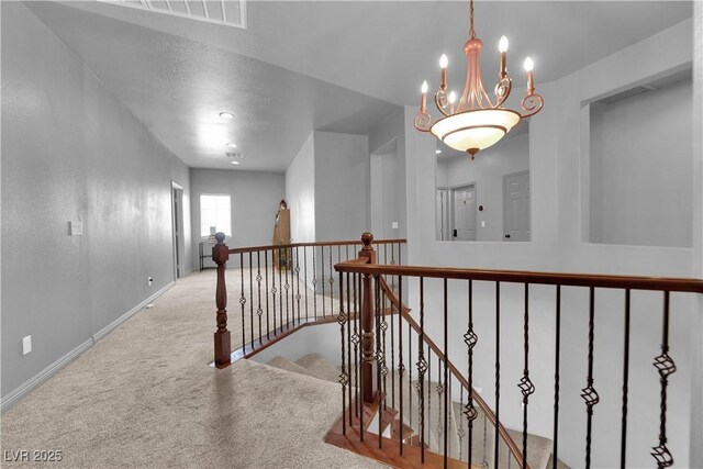 1808 Peyton Stewart Ct, North Las Vegas, NV 89086 - hall featuring carpet flooring, baseboards, an upstairs landing, and a chandelier