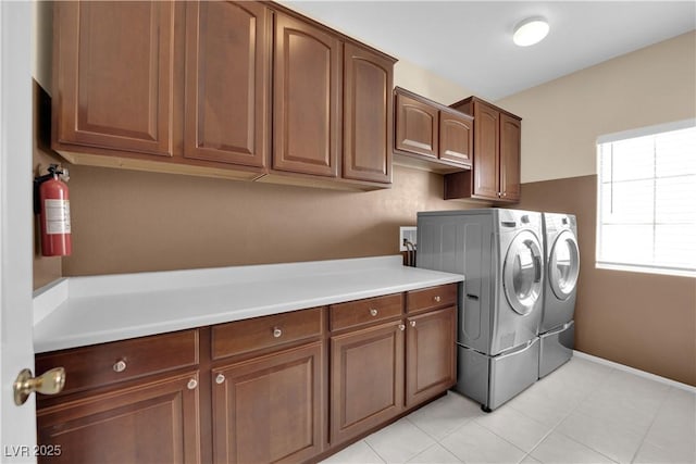 1808 Peyton Stewart Ct, North Las Vegas, NV 89086 - laundry area featuring cabinet space, washer and dryer, baseboards, and light tile patterned floors