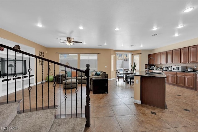 1808 Peyton Stewart Ct, North Las Vegas, NV 89086 - kitchen with dark countertops, a center island, baseboards, healthy amount of natural light, and recessed lighting