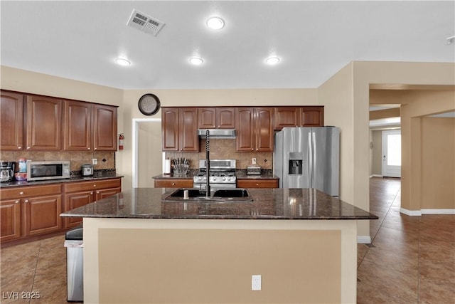 1808 Peyton Stewart Ct, North Las Vegas, NV 89086 - kitchen featuring stainless steel appliances, a sink, under cabinet range hood, and backsplash