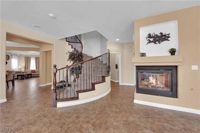 1808 Peyton Stewart Ct, North Las Vegas, NV 89086 - stairway featuring a multi sided fireplace, baseboards, tile patterned flooring, and recessed lighting