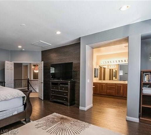 1808 Peyton Stewart Ct, North Las Vegas, NV 89086 - bedroom with dark wood-style flooring, baseboards, recessed lighting, and connected bathroom