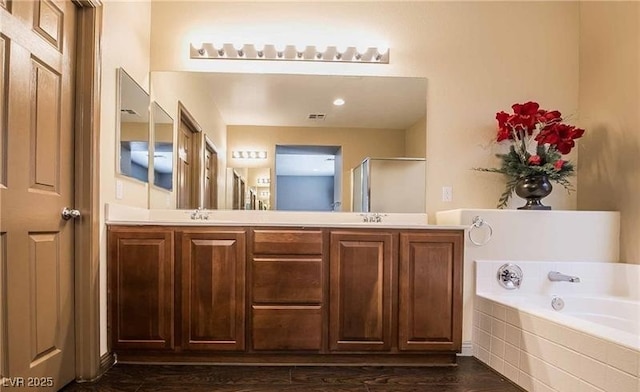 1808 Peyton Stewart Ct, North Las Vegas, NV 89086 - full bathroom featuring a garden tub, double vanity, wood finished floors, and a shower with shower door