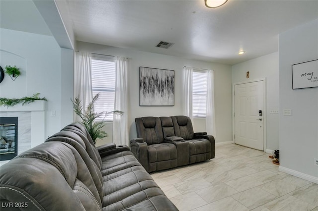 11004 Napa Ridge Dr, Las Vegas, NV 89144 - living room with a high end fireplace, light marble finish floors, and baseboards