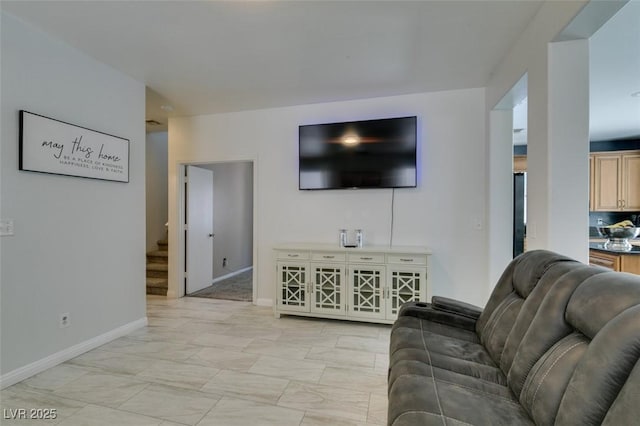 11004 Napa Ridge Dr, Las Vegas, NV 89144 - living area with baseboards, light marble finish floors, and stairway