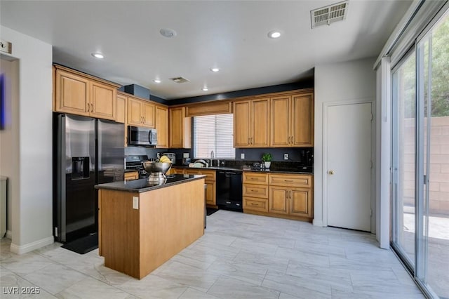 11004 Napa Ridge Dr, Las Vegas, NV 89144 - kitchen featuring fridge with ice dispenser, stainless steel microwave, dishwasher, dark countertops, and a center island