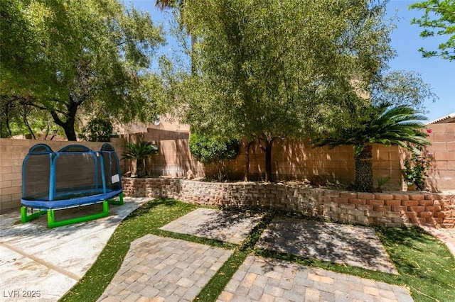 11004 Napa Ridge Dr, Las Vegas, NV 89144 - fenced backyard with a trampoline and a patio area