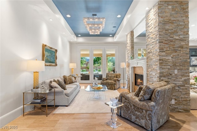11 Misty Peaks Ct, Las Vegas, NV 89135 - living room with a lit fireplace, a raised ceiling, and recessed lighting