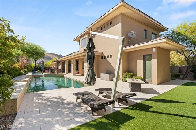 11 Misty Peaks Ct, Las Vegas, NV 89135 - back of property with stucco siding, a patio area, an outdoor pool, a mountain view, and a yard