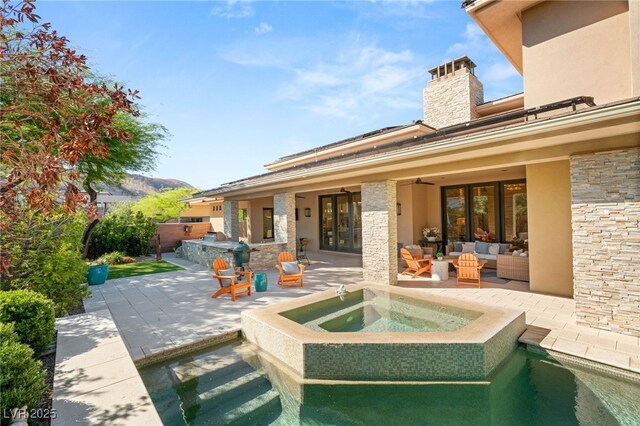 11 Misty Peaks Ct, Las Vegas, NV 89135 - view of patio / terrace featuring outdoor lounge area, french doors, a ceiling fan, and a pool with connected hot tub