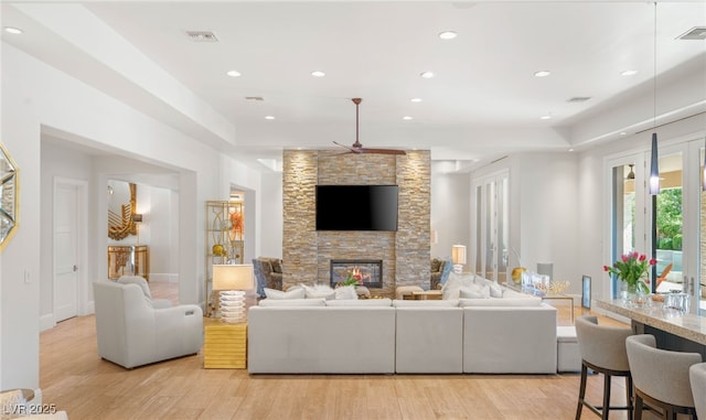11 Misty Peaks Ct, Las Vegas, NV 89135 - living room featuring light wood-type flooring, ceiling fan, a stone fireplace, recessed lighting, and baseboards