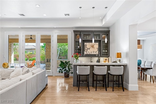 11 Misty Peaks Ct, Las Vegas, NV 89135 - indoor wet bar with french doors, pendant lighting, light wood-style floors, and recessed lighting