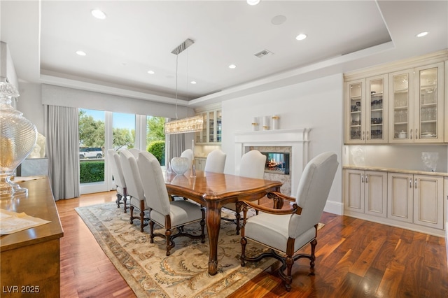 11 Misty Peaks Ct, Las Vegas, NV 89135 - dining space featuring a tray ceiling, wood finished floors, recessed lighting, and a fireplace