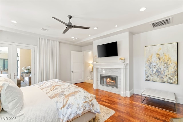 11 Misty Peaks Ct, Las Vegas, NV 89135 - bedroom with wood finished floors, access to outside, recessed lighting, a tiled fireplace, and a ceiling fan