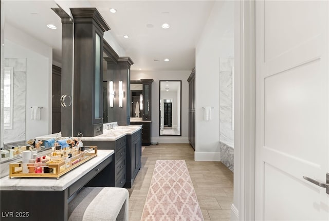 11 Misty Peaks Ct, Las Vegas, NV 89135 - full bathroom with vanity, a tub with marble appearance, baseboards, recessed lighting, and wood finished floors