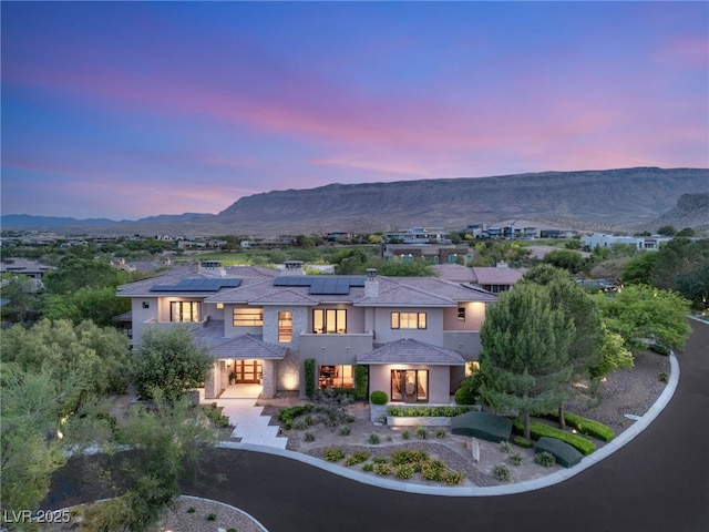 11 Misty Peaks Ct, Las Vegas, NV 89135 - mediterranean / spanish home with stucco siding, a mountain view, and solar panels