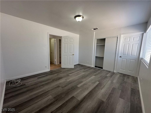 6905 Singing Dunes Ln, Las Vegas, NV 89145 - unfurnished bedroom with dark wood-style flooring, baseboards, and a closet