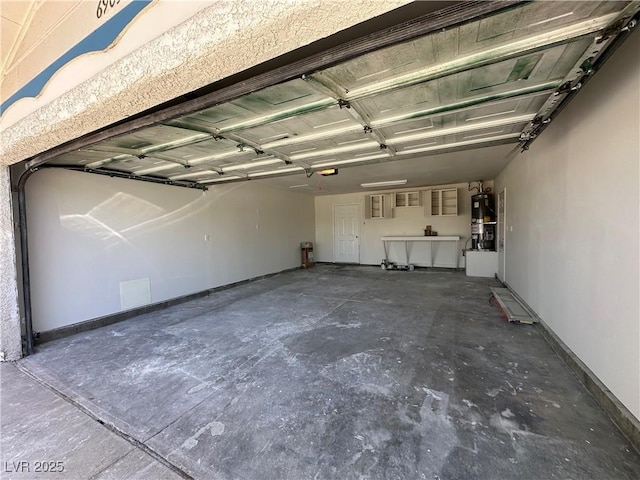 6905 Singing Dunes Ln, Las Vegas, NV 89145 - garage featuring gas water heater, baseboards, and a garage door opener