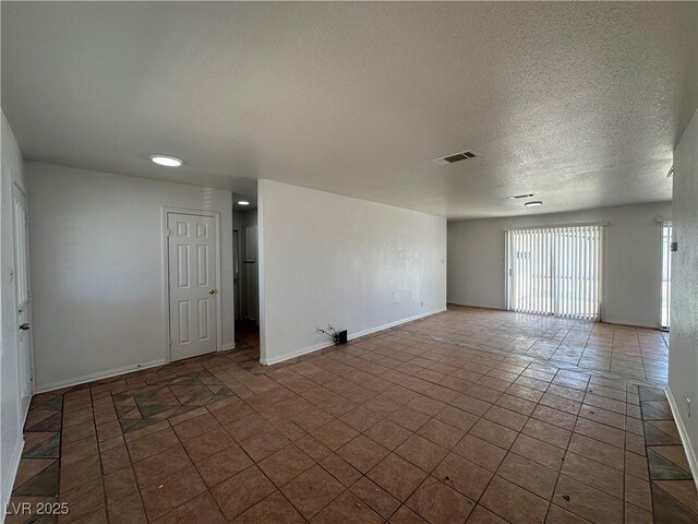 6905 Singing Dunes Ln, Las Vegas, NV 89145 - tiled spare room with a textured ceiling and baseboards