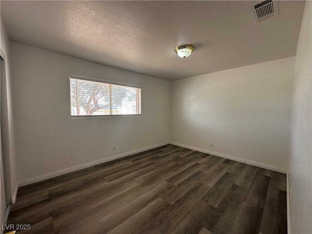 6905 Singing Dunes Ln, Las Vegas, NV 89145 - empty room featuring dark wood-style flooring, baseboards, and a textured ceiling