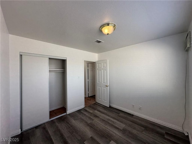 6905 Singing Dunes Ln, Las Vegas, NV 89145 - unfurnished bedroom with dark wood-style flooring, baseboards, and a closet