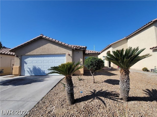 2711 Morning Break Ct, Las Vegas, NV 89142 - view of home's exterior featuring stucco siding, a tiled roof, driveway, and an attached garage