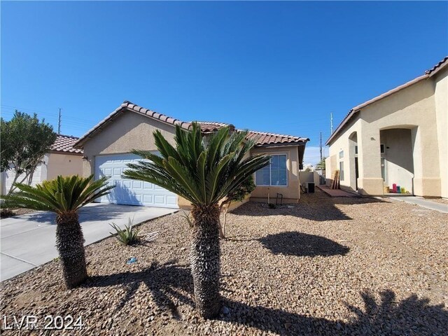 2711 Morning Break Ct, Las Vegas, NV 89142 - view of front of house with a garage, stucco siding, driveway, and a tile roof