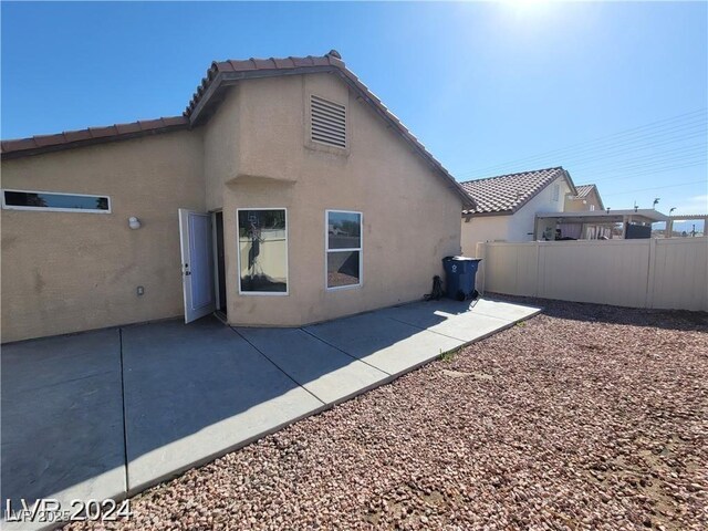 2711 Morning Break Ct, Las Vegas, NV 89142 - back of property with stucco siding, a patio, and a tiled roof