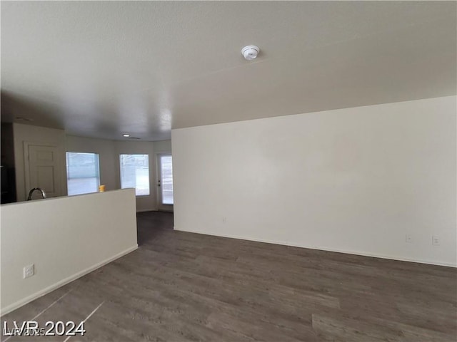 2711 Morning Break Ct, Las Vegas, NV 89142 - empty room featuring dark wood-style floors, a smoke detector, and baseboards