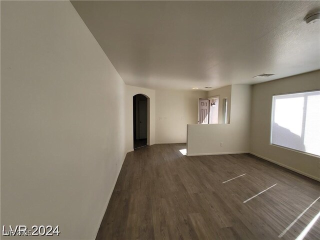2711 Morning Break Ct, Las Vegas, NV 89142 - spare room with arched walkways, dark wood-style flooring, baseboards, and a smoke detector