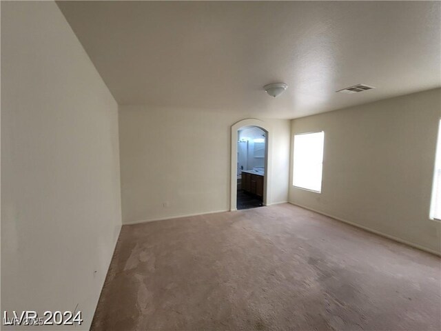 2711 Morning Break Ct, Las Vegas, NV 89142 - carpeted spare room featuring arched walkways and baseboards