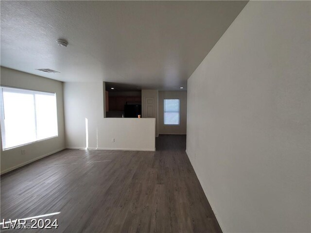 2711 Morning Break Ct, Las Vegas, NV 89142 - unfurnished living room featuring dark wood finished floors and baseboards