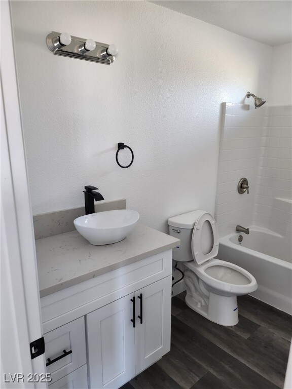 4231 E Kellogg Rd, Pahrump, NV 89061 - bathroom featuring vanity, toilet, shower / tub combination, and wood finished floors