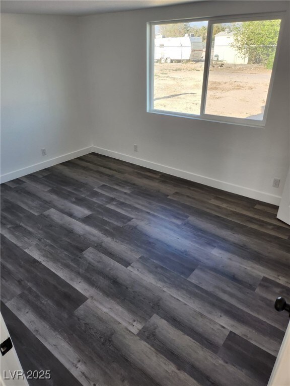 4231 E Kellogg Rd, Pahrump, NV 89061 - unfurnished room featuring dark wood finished floors and baseboards