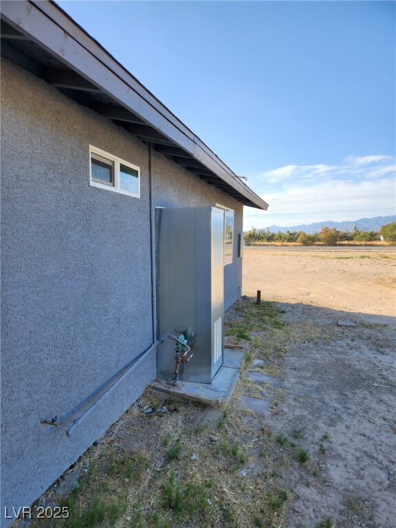 4231 E Kellogg Rd, Pahrump, NV 89061 - view of property exterior featuring stucco siding and a mountain view