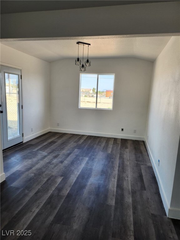 4231 E Kellogg Rd, Pahrump, NV 89061 - unfurnished dining area featuring plenty of natural light, dark wood-style floors, and baseboards