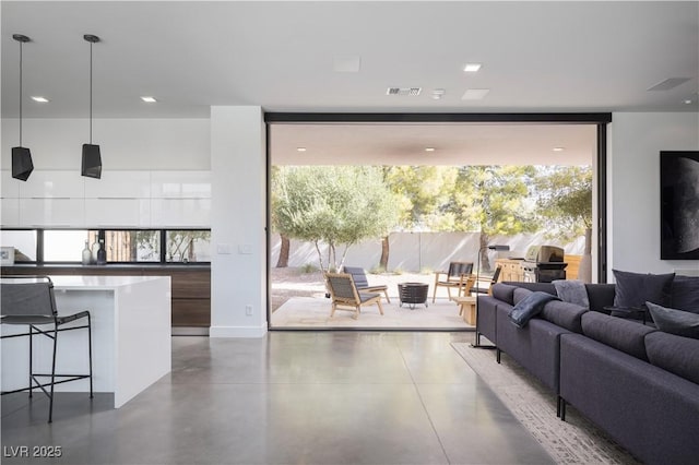 7030 Schirlls St, Las Vegas, NV 89118 - living room with expansive windows and concrete flooring