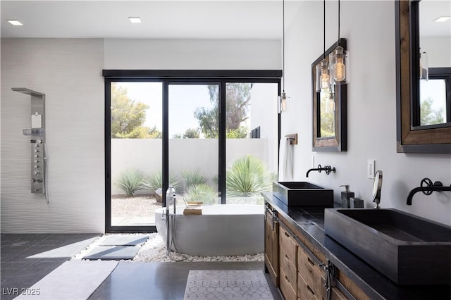 7030 Schirlls St, Las Vegas, NV 89118 - bathroom featuring double vanity and a freestanding tub