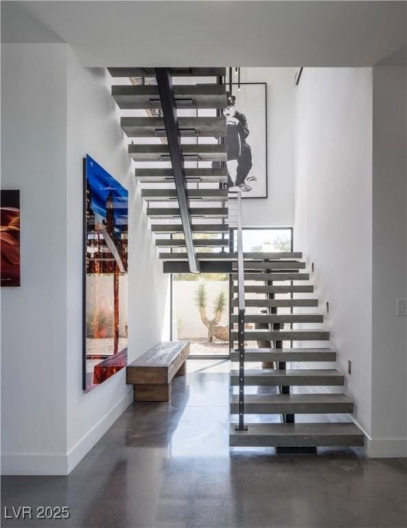 7030 Schirlls St, Las Vegas, NV 89118 - stairs with healthy amount of natural light, finished concrete floors, and baseboards