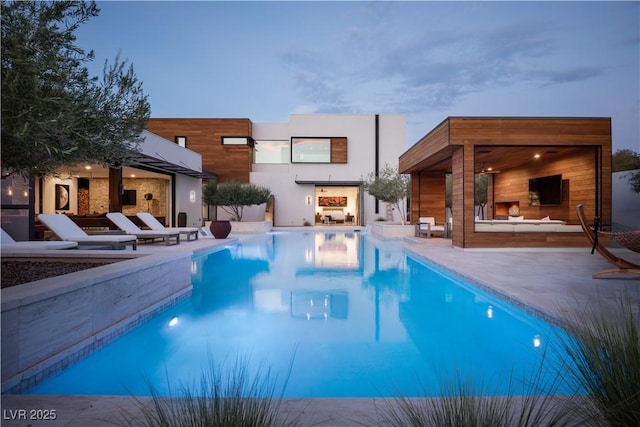 7030 Schirlls St, Las Vegas, NV 89118 - outdoor pool with a multi sided fireplace, a patio area, a storage structure, and an outdoor structure