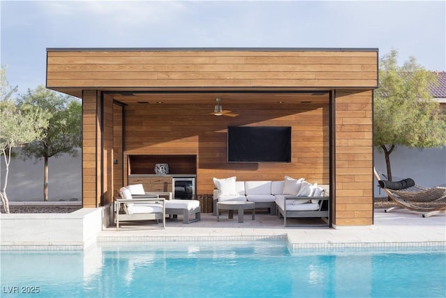 7030 Schirlls St, Las Vegas, NV 89118 - outdoor pool with an outdoor living space and an outbuilding